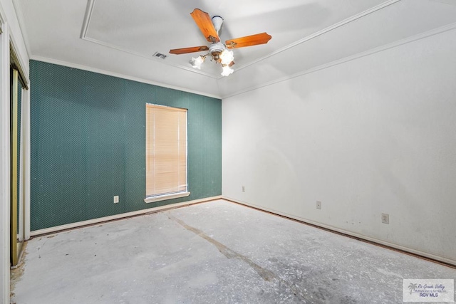 empty room with ornamental molding, a ceiling fan, attic access, and visible vents