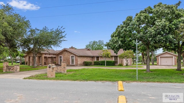 ranch-style house with brick siding, a garage, and a front lawn