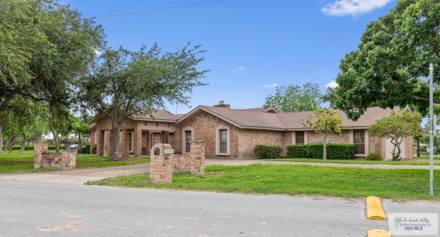 single story home with brick siding and a front lawn