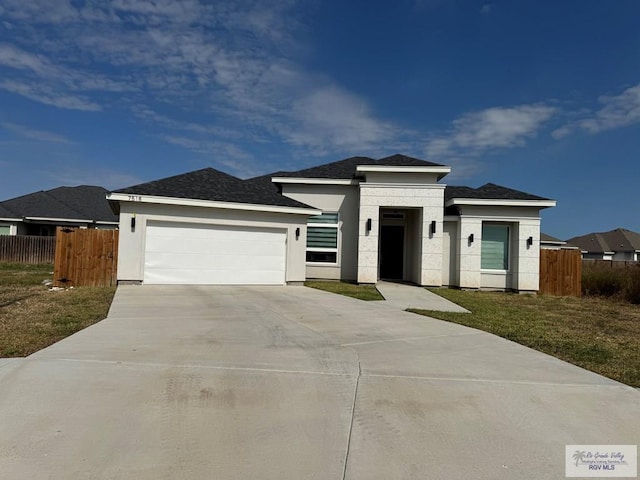 prairie-style home featuring a garage and a front yard