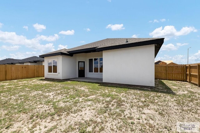 324 N Leon Ave, Elsa, TX 78543 - rear view of property featuring stucco siding
