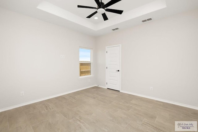 324 N Leon Ave, Elsa, TX 78543 - unfurnished room with a raised ceiling, ceiling fan, and baseboards
