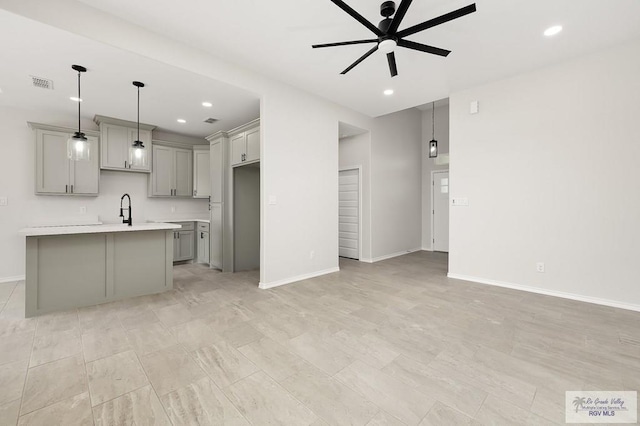324 N Leon Ave, Elsa, TX 78543 - kitchen with gray cabinetry, ceiling fan, light countertops, a sink, and recessed lighting