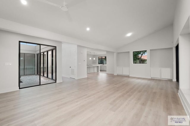 unfurnished living room with lofted ceiling and light hardwood / wood-style flooring