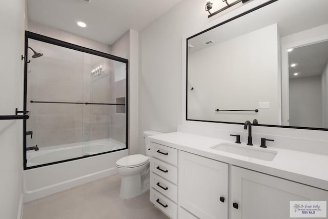 full bathroom with vanity, toilet, and bath / shower combo with glass door