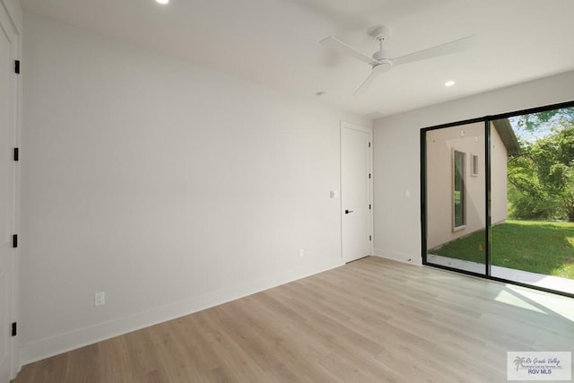 empty room with ceiling fan and light wood-type flooring