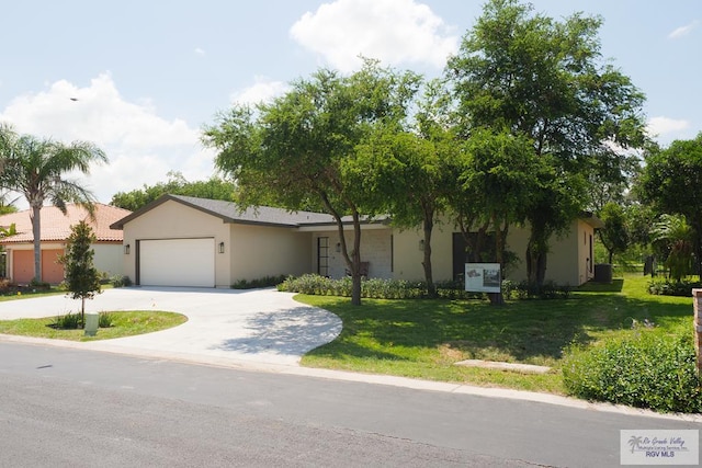 view of front of home with a front yard and a garage