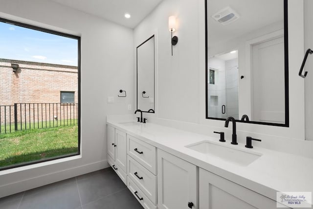 bathroom featuring tile patterned floors, vanity, and an enclosed shower