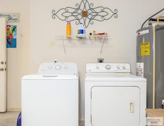 laundry room with electric water heater and washer and clothes dryer