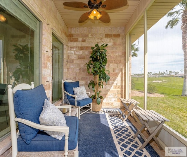 sunroom / solarium featuring ceiling fan and wood ceiling