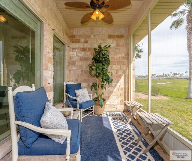 sunroom / solarium featuring ceiling fan and wood ceiling