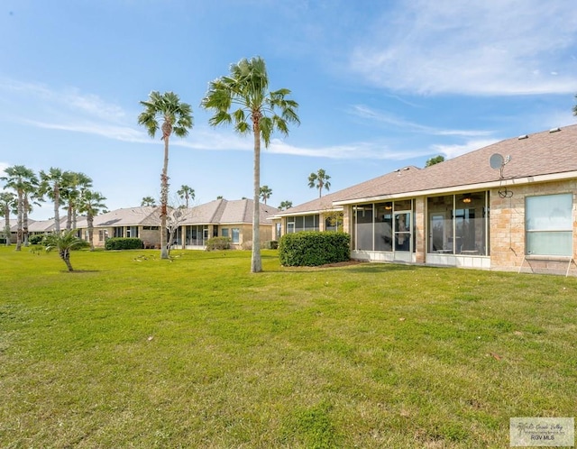 view of yard with a sunroom