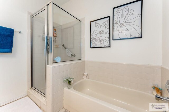 bathroom with separate shower and tub