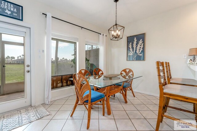 dining area with light tile patterned floors and a notable chandelier