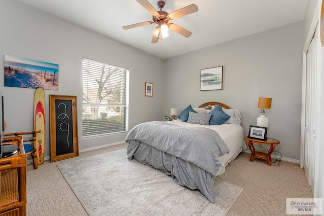 carpeted bedroom featuring ceiling fan and a closet