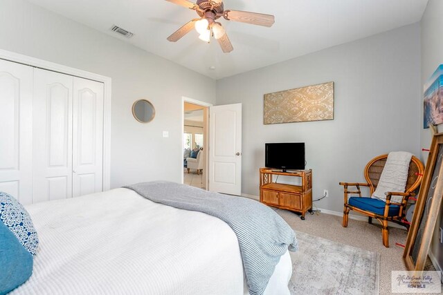 bedroom featuring ceiling fan, a closet, and light carpet