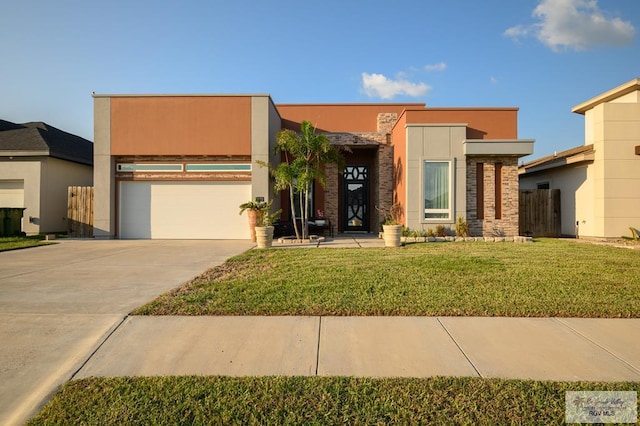 contemporary home featuring a front lawn and a garage