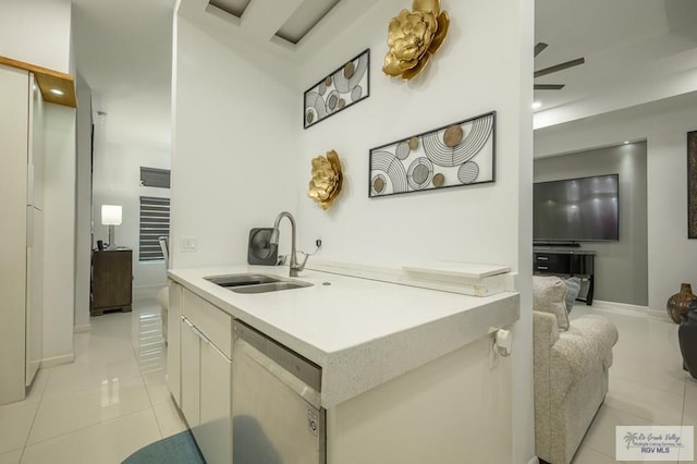 kitchen with light tile patterned floors, stainless steel dishwasher, ceiling fan, and sink