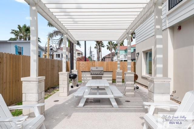 115 Marlin St Unit C, South Padre Island, TX 78597 - view of patio / terrace featuring a pergola and outdoor dining area