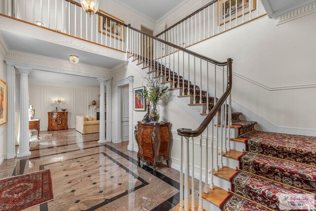 2301 Riverside Dr, Harlingen, TX 78550 - stairs featuring a decorative wall, a high ceiling, baseboards, ornamental molding, and ornate columns