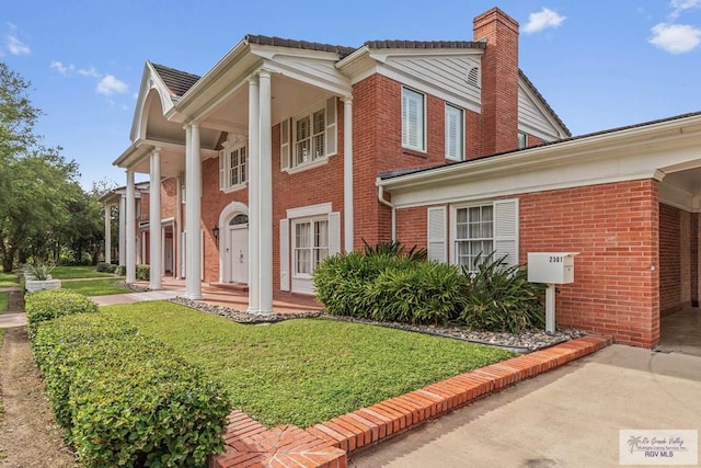 2301 Riverside Dr, Harlingen, TX 78550 - view of front of house with a front lawn and brick siding