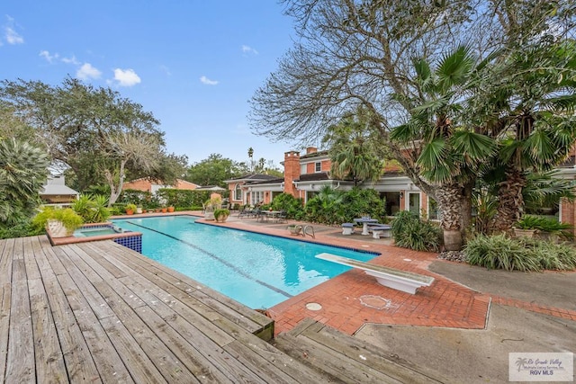 2301 Riverside Dr, Harlingen, TX 78550 - view of pool with a pool with connected hot tub, a diving board, and a patio