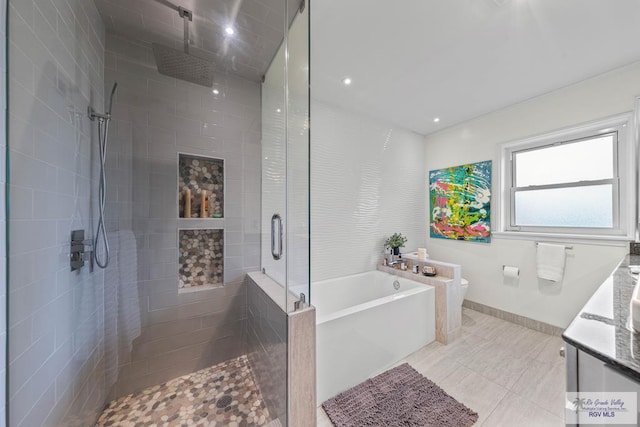2301 Riverside Dr, Harlingen, TX 78550 - bathroom with toilet, a stall shower, tile patterned flooring, baseboards, and a bath