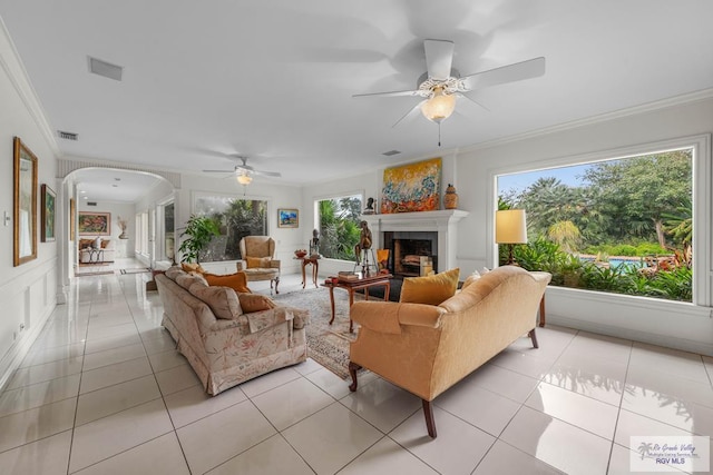 2301 Riverside Dr, Harlingen, TX 78550 - living area with a fireplace, crown molding, visible vents, and light tile patterned floors