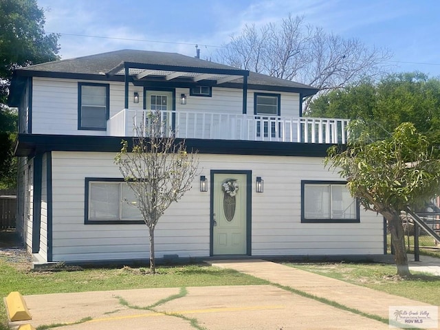 view of front of house featuring a balcony
