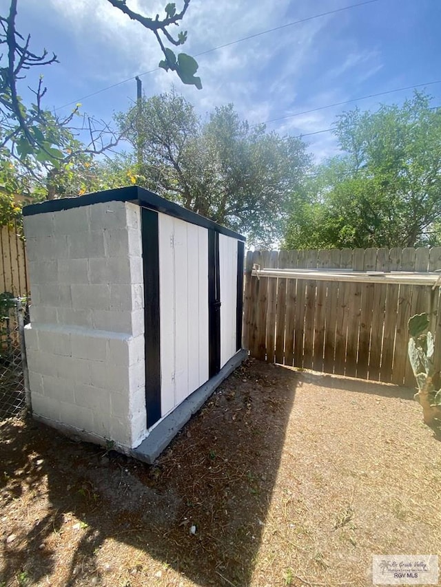 view of shed with fence
