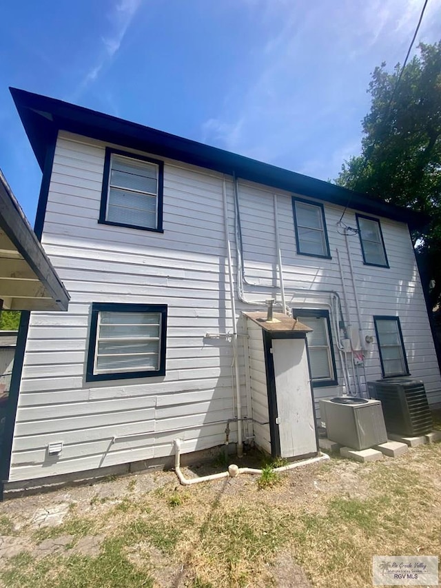 rear view of house featuring central AC unit