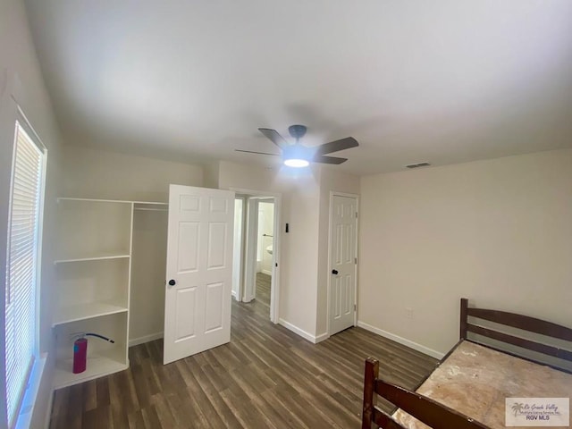 unfurnished bedroom with a ceiling fan, wood finished floors, a closet, baseboards, and visible vents