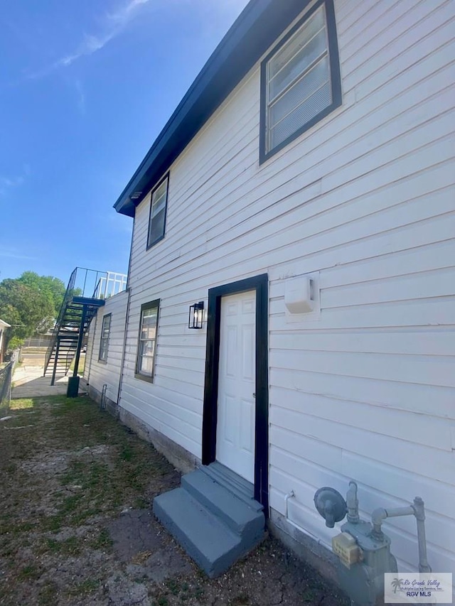 back of house with entry steps and stairs