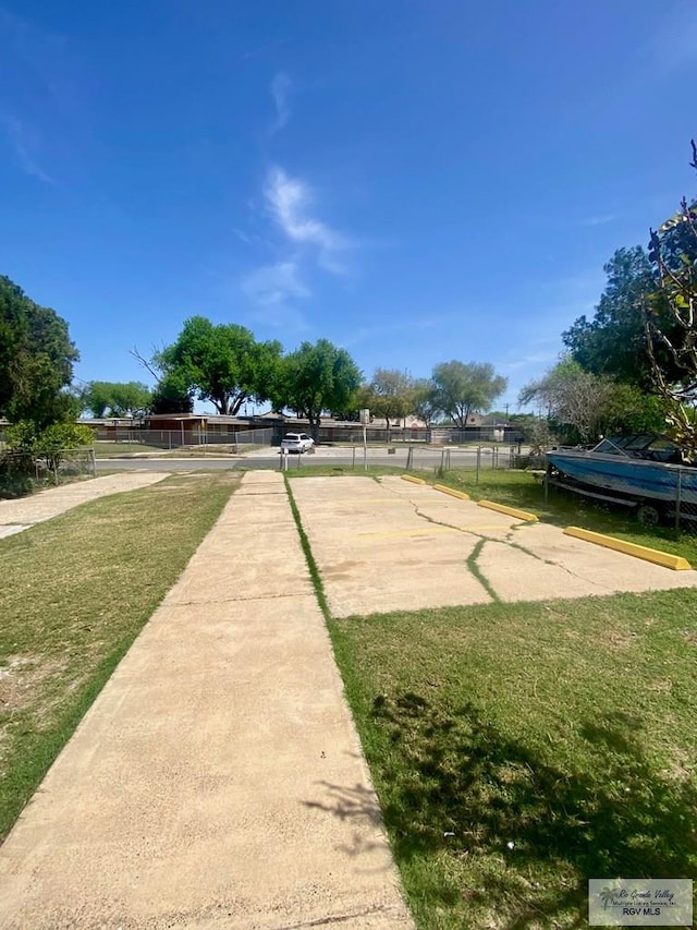surrounding community featuring a yard and fence