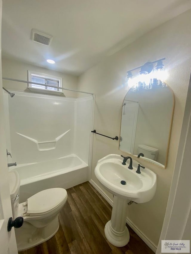 full bath with wood finished floors, visible vents, toilet, and bathing tub / shower combination