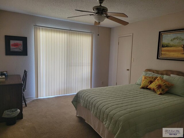 bedroom with a textured ceiling, carpet floors, and ceiling fan