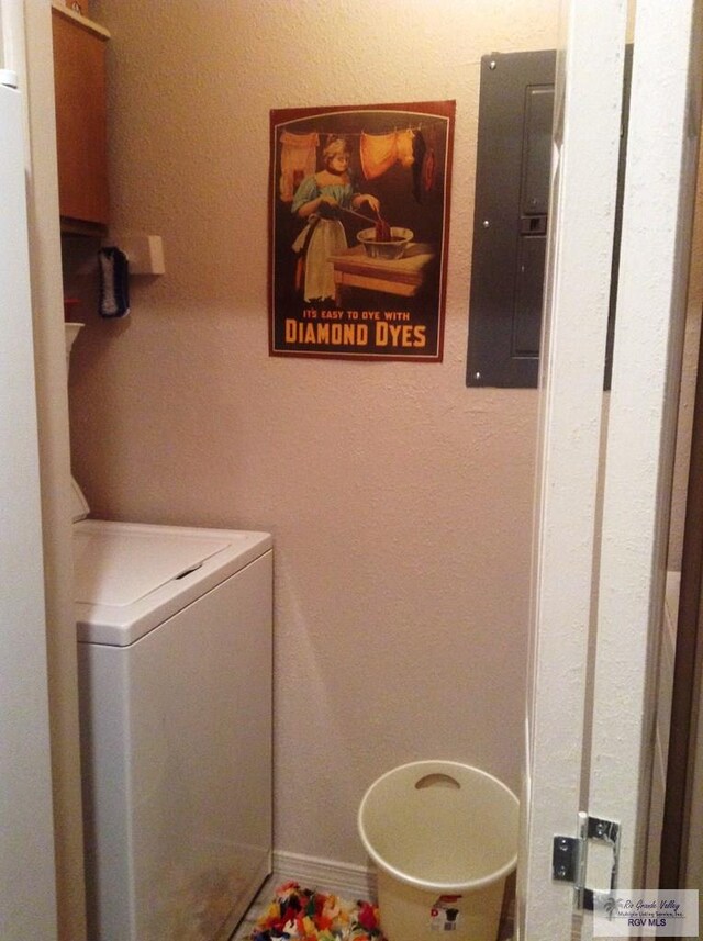 washroom featuring electric panel and washer / clothes dryer