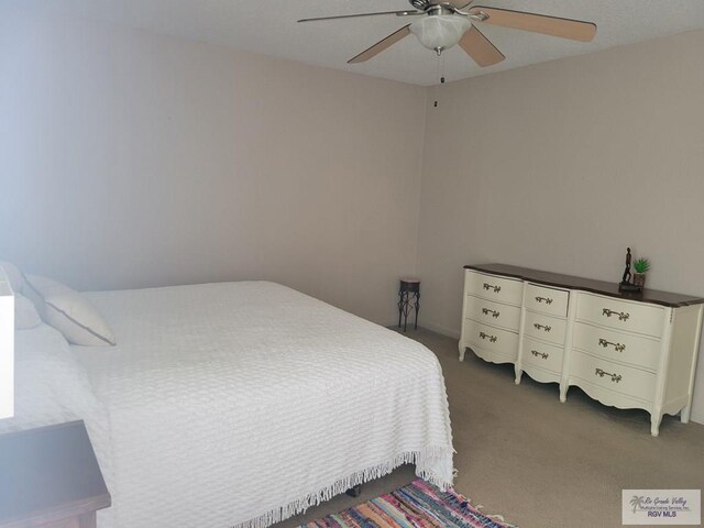 bedroom featuring dark carpet and ceiling fan