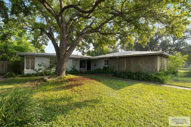 rear view of property featuring a lawn