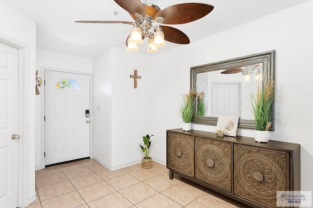 entrance foyer with ceiling fan and light tile patterned floors