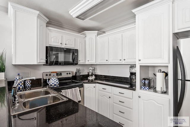 kitchen featuring dark stone countertops, white cabinetry, sink, and appliances with stainless steel finishes