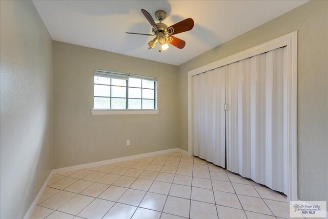 1544 W San Marcelo Blvd, Brownsville, TX 78526 - unfurnished bedroom with a ceiling fan, baseboards, light tile patterned floors, and a closet