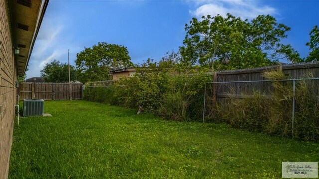 1544 W San Marcelo Blvd, Brownsville, TX 78526 - view of yard featuring central air condition unit and a fenced backyard