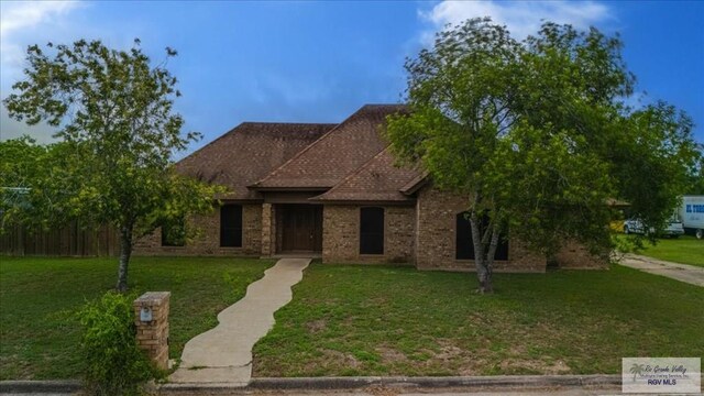 1544 W San Marcelo Blvd, Brownsville, TX 78526 - view of front facade featuring brick siding and a front yard