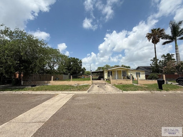 165 Johns Ave, Brownsville, TX 78521 - bungalow-style house featuring a fenced front yard, a gate, and concrete driveway