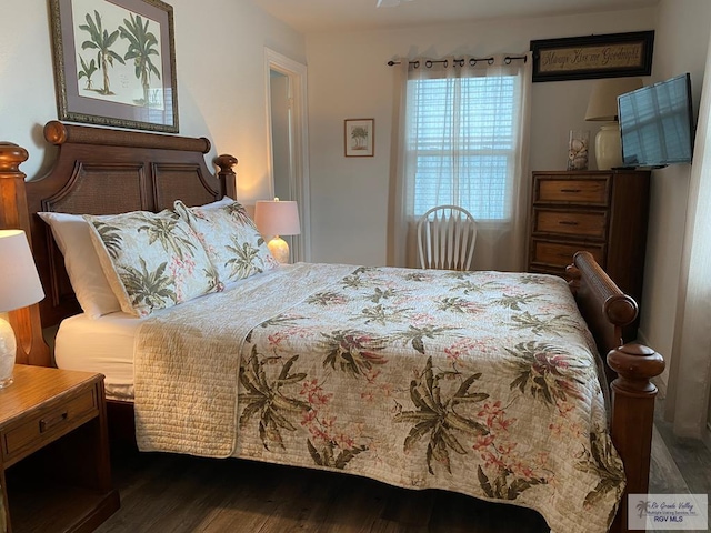 bedroom with dark wood-type flooring