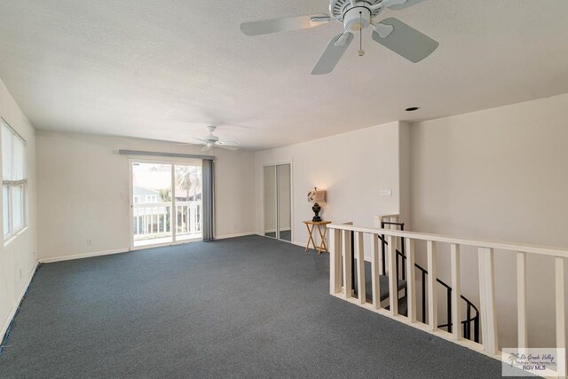 empty room featuring ceiling fan and carpet floors