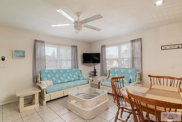 tiled living room with ceiling fan and plenty of natural light