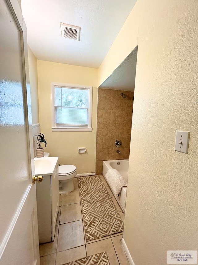 2301 E Monroe St, Harlingen, TX 78550 - full bath featuring vanity, tile patterned floors, shower / bath combination, and a textured wall