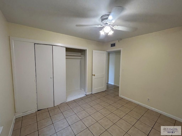 2301 E Monroe St, Harlingen, TX 78550 - unfurnished bedroom featuring a closet, light tile patterned floors, and ceiling fan